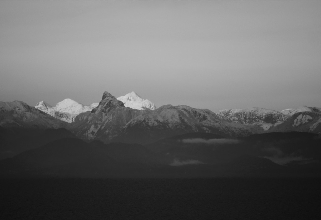 Snowy coastal mountains above the water, Vancouver Island